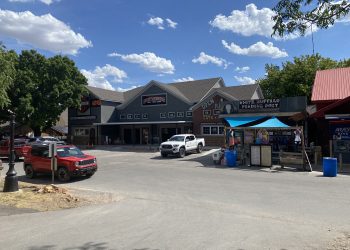 Construction continues on Diamondback Harley-Davison’s Medicine Park clothing outlet Wednesday afternoon. Inside a crew member makes some adjustments to the retail center’s patio doors overlooking Bath Lake. The shop is expected to open mid to late August. Pphoto by Curtis Awbrey