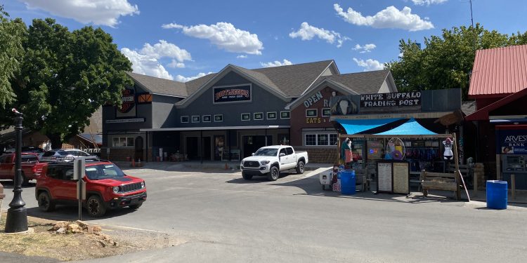 Construction continues on Diamondback Harley-Davison’s Medicine Park clothing outlet Wednesday afternoon. Inside a crew member makes some adjustments to the retail center’s patio doors overlooking Bath Lake. The shop is expected to open mid to late August. Pphoto by Curtis Awbrey
