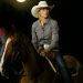With a full moon rising over the event Barrel Racer Savannah Woodfin waits her turn at the rodeo. RIP STELL PHOTOS