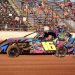 WAITING: Jim Bland sits in the seat of the No. 16 car as the fans rise in the background in anticipation of the national anthem before the start of the Rob Bland Memorial Race. Photo by Mike Howard Photography