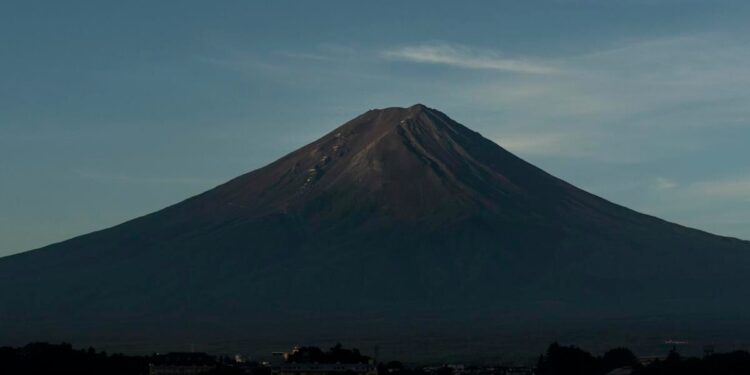 It's not official yet but Mount Fuji gets its trademark snowcap after the longest delay in 130 years